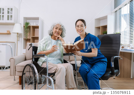 Elderly care concept. Portrait of nurse and her senior client on wheelchair. Elderly care concept. Portrait of nurse and her senior client on wheelchair. 135076911