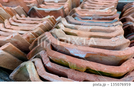 Angled View of Stacked Traditional Clay Roof Tiles, Terracotta Material Texture 135076959