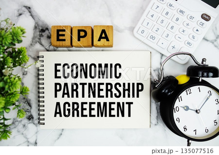 EPA Economic Partnership Agreement text with calculator and alarm clock on marble background 135077516