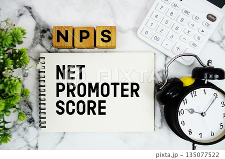 NPS Net Promoter Score text with calculator and alarm clock on marble background 135077522