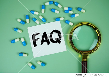 FAQ with medicine capsule and magnifying glass on green background FAQ with medicine capsule and magnifying glass on green background 135077650