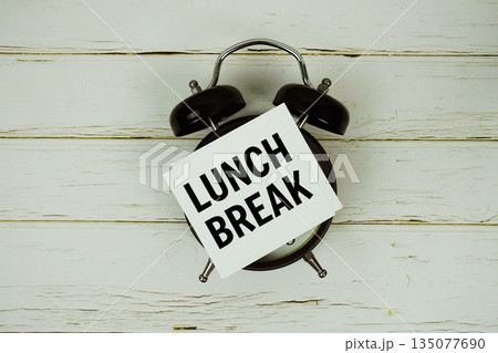 Lunch Break text with alarm clock on wooden background Lunch Break text with alarm clock on wooden background 135077690