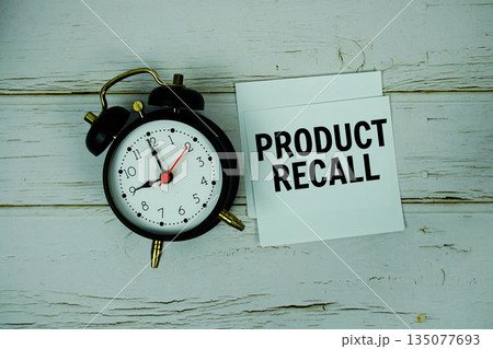 Product Recall text with alarm clock on wooden background 135077693