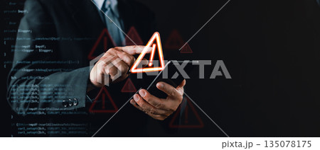 businessman in a suit uses a smartphone with floating warning icons and digital code overlay, symbolizing cybersecurity threats, system vulnerabilities, caution alerts, and digital risk awareness. 135078175