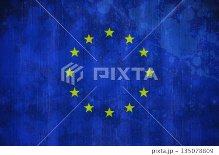 Displaying flat design EU flag with textured blue backdrop featuring circle of twelve yellow stars 135078809