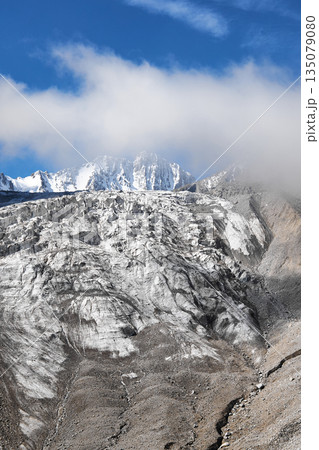 Majestic mountain range with large glacier on its slope, ice and rock formations Majestic mountain range with large glacier on its slope, ice and rock formations 135079080
