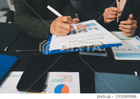business people in meeting discussing plans together 135080066