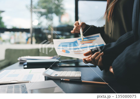 business people in meeting discussing plans together business people in meeting discussing plans together 135080075