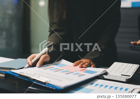 business people in meeting discussing plans together 135080077