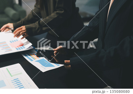 business people in meeting discussing plans together 135080080