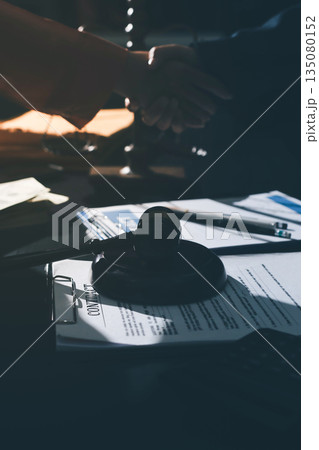 Consultation and conference of professional businesswoman and Male lawyers working and discussion having at law firm in office. Concepts of law, Judge gavel with scales of justice 135080152