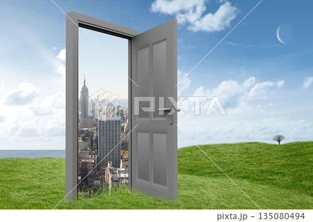 Digital image of door opening at cityscape on grassy hill 135080494