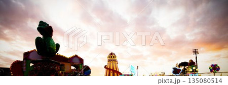 Green frog sculpture is perching on fairground platform in flat design with striped slide tower Green frog sculpture is perching on fairground platform in flat design with striped slide tower 135080514