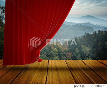 Red velvet curtain is revealing misty forest and mountain valley on wooden stage in flat design 135080613