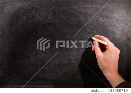 Man drawing on chalkboard Man drawing on chalkboard 135080719