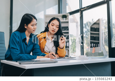 Businesswomen having discussion in office Businesswomen having discussion in office 135081243