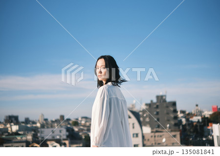 都会の街並みと若い女性 135081841