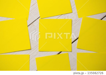 Yellow papers on wooden flooring 135082726