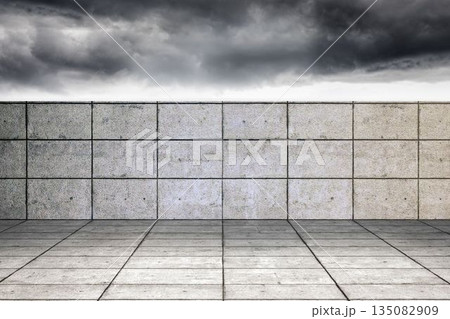 Tiled concrete courtyard is showcasing grid floor and matching wall in flat design under stormy sky 135082909