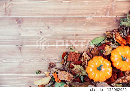 Overhead view of pumpkins with leaves on table Overhead view of pumpkins with leaves on table 135082923