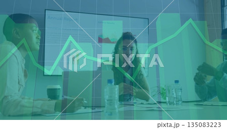 Reviewing chart display, woman wearing glasses leading discussion at conference room, with laptops 135083223