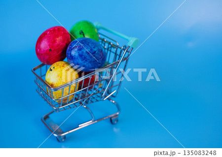 Happy Easter concept with easter eggs in shopping cart. Happy Easter concept with easter eggs in shopping cart. 135083248