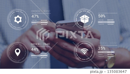 Reviewing executive hands tapping tracking overlays on phone at office, with gear and box icons 135083647