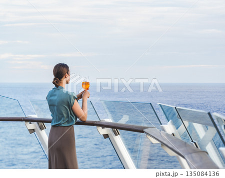 Stylish woman with a glass of drink Stylish woman with a glass of drink 135084136