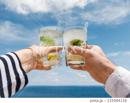 Men's and women's hands and glasses with drinks Men's and women's hands and glasses with drinks 135084138