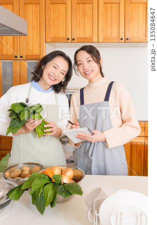 母から料理を教わる娘 母から料理を教わる娘 135084647
