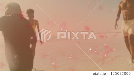 Walking family wearing shorts, one-piece and trunks on shoreline, with water and pink sparkles Walking family wearing shorts, one-piece and trunks on shoreline, with water and pink sparkles 135085009