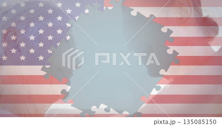 Displaying older man and woman profiles facing each other in studio, with US flag puzzle piece Displaying older man and woman profiles facing each other in studio, with US flag puzzle piece 135085150