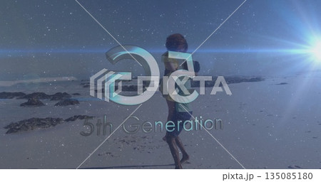 Piggybacking couple in swimwear walking along beach, with lens flare, 5th Generation logo overlay 135085180