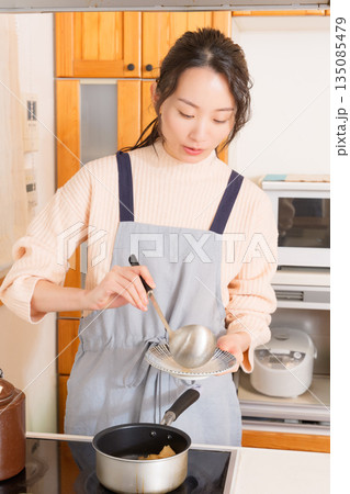 肉じゃがをお皿によそう若い女性 肉じゃがをお皿によそう若い女性 135085479