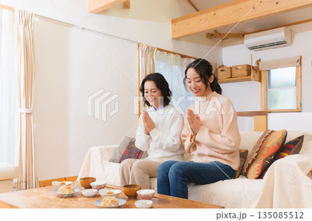 手を合わせて一緒にごはんを食べる母と娘 135085512