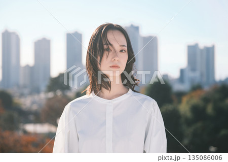 都会の街並みと若い女性 都会の街並みと若い女性 135086006