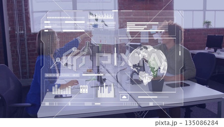 Pointing colleagues showing data trends in modern office, with printed chart, holographic overlays 135086284