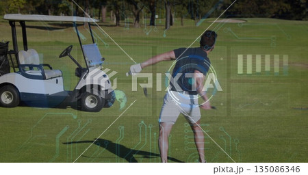 Swinging adult male golfer taking backswing on golf fairway, with golf club, cart and HUD graphics 135086346