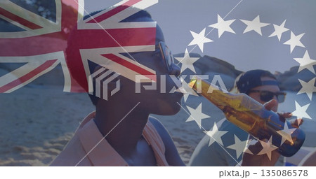 Drinking woman wearing aviators holding bottle at beach, Union Jack, stars overlays, copy space 135086578