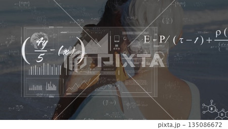 Viewing senior couple examining sea shore data overlay, with binoculars, charts and equations 135086672