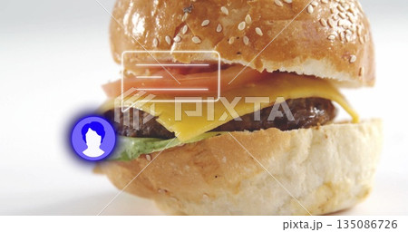 Stacking sesame burger with cheddar, beef patty, lettuce, tomato in studio, with graphic overlays Stacking sesame burger with cheddar, beef patty, lettuce, tomato in studio, with graphic overlays 135086726