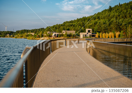 Aerial view of Terhills blue lagoon, green hills, and bike lane tracing the former Eisden coal mine site in Belgium. Aerial view of Terhills blue lagoon, green hills, and bike lane tracing the former Eisden coal mine site in Belgium. 135087206