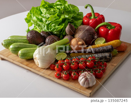 Assortment of fresh organic vegetables in baskets at a farmers market or supermarket. Healthy natural products for diet, clean eating, and sustainable lifestyle. 135087245