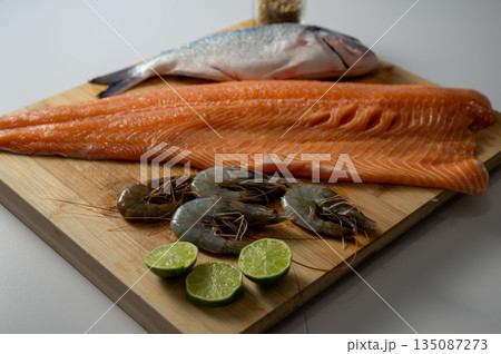 Healthy seafood assortment featuring fresh salmon, dorado, and shrimps. Clean, nutritious food concept with natural ingredients rich in protein and omega-3. Healthy seafood assortment featuring fresh salmon, dorado, and shrimps. Clean, nutritious food concept with natural ingredients rich in protein and omega-3. 135087273