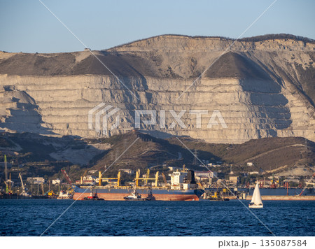 Large cargo ship Kual Bang Hai 16 entering the port of Novorossiysk Russia. Commercial vessel arriving at the Black Sea port. 135087584