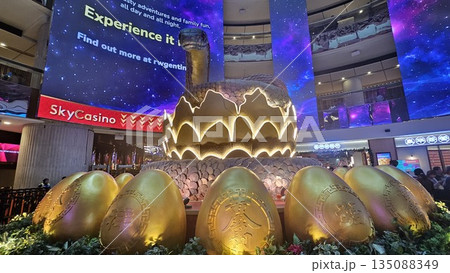 this is snake sculpture coils around golden eggs with Chinese calligraphy 135088349