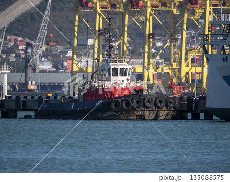 August 22 2025 View of Novorossiysk port Russia with cargo ships and cranes on the coastline. Industrial maritime scene on the Black Sea 135088575
