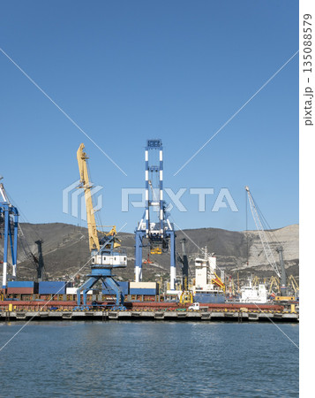 August 22 2025 View of Novorossiysk port Russia with cargo ships and cranes on the coastline. Industrial maritime scene on the Black Sea August 22 2025 View of Novorossiysk port Russia with cargo ships and cranes on the coastline. Industrial maritime scene on the Black Sea 135088579