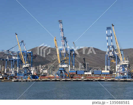 August 22 2025 View of Novorossiysk port Russia with cargo ships and cranes on the coastline. Industrial maritime scene on the Black Sea August 22 2025 View of Novorossiysk port Russia with cargo ships and cranes on the coastline. Industrial maritime scene on the Black Sea 135088581