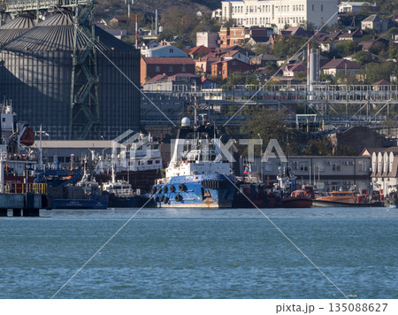 August 22 2025 View of Novorossiysk port Russia with cargo ships and cranes on the coastline. Industrial maritime scene on the Black Sea August 22 2025 View of Novorossiysk port Russia with cargo ships and cranes on the coastline. Industrial maritime scene on the Black Sea 135088627